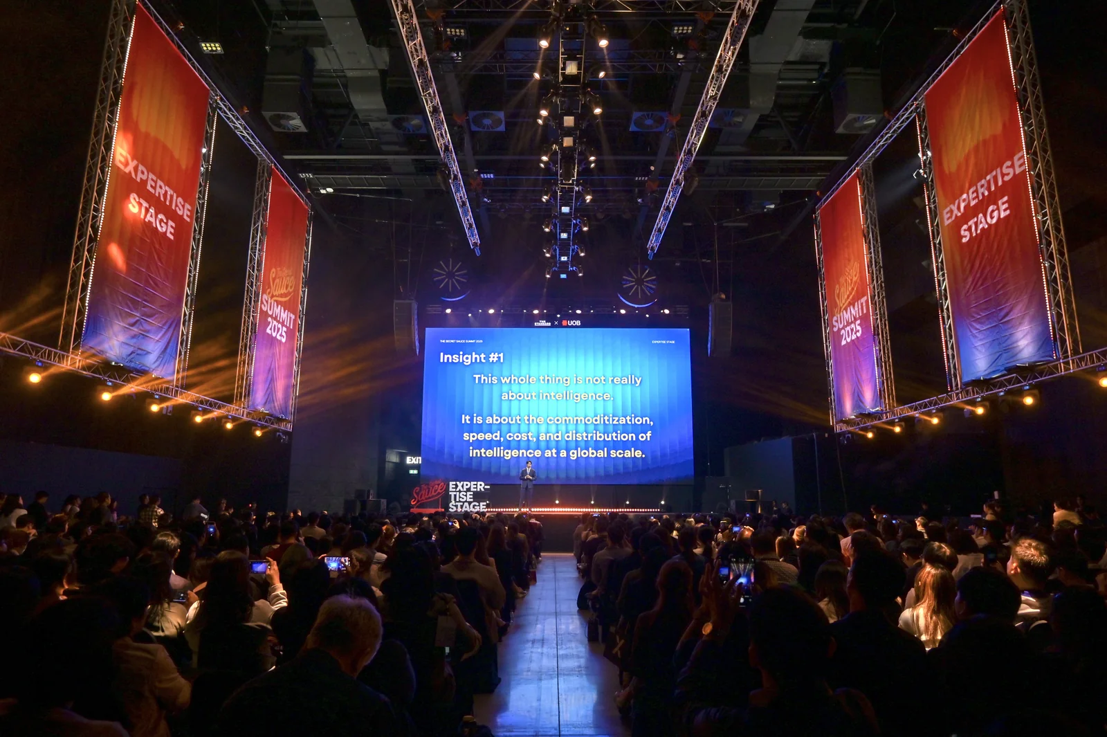 An audience attending a presentation in a large auditorium.