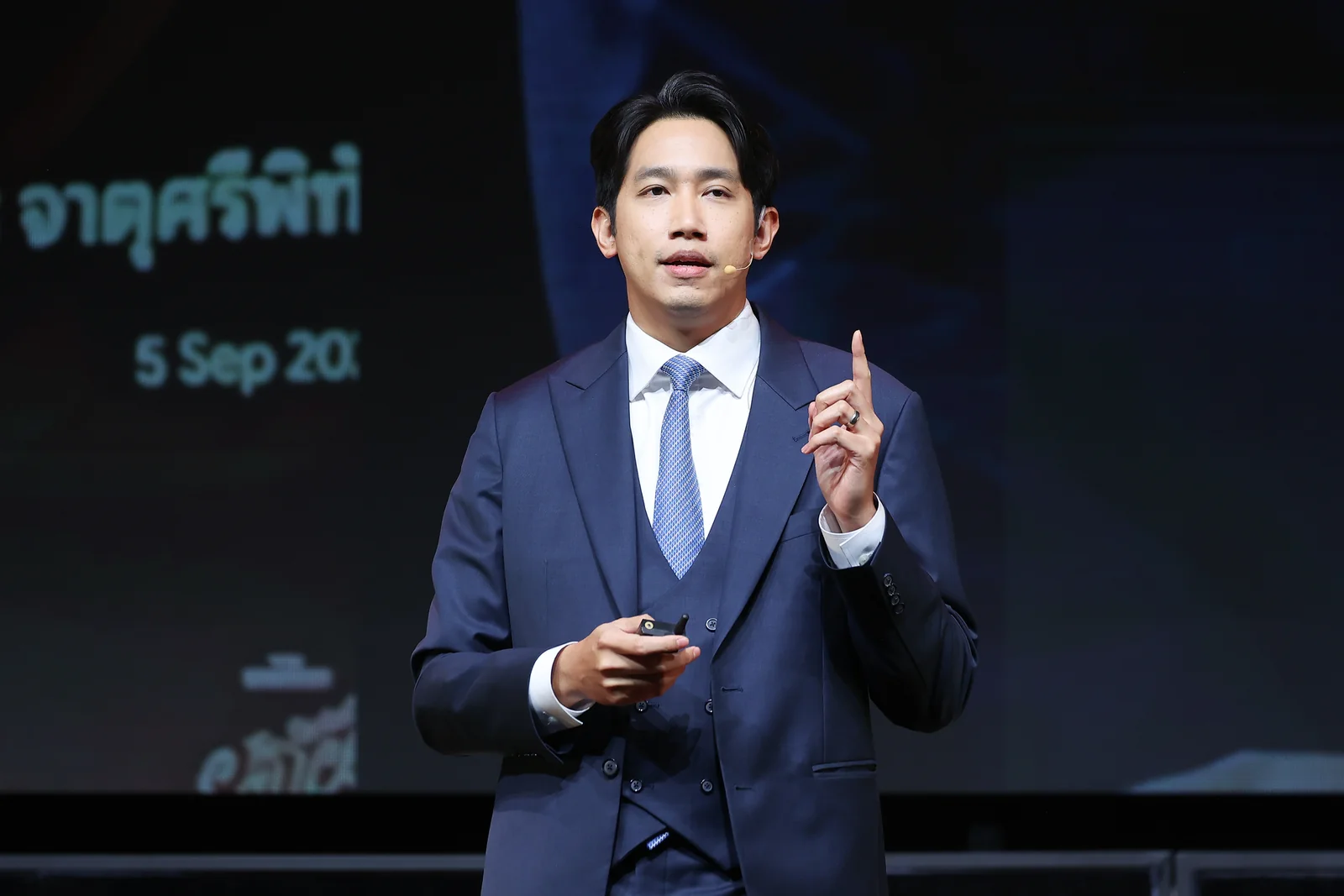 A speaker making a point during a keynote.